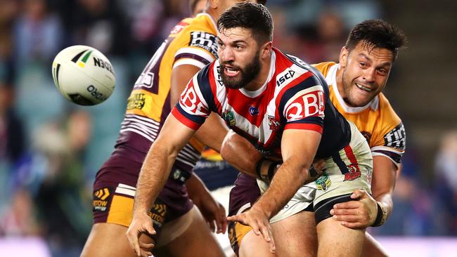 SYDNEY, AUSTRALIA - AUGUST 25: James Tedesco of the Roosters passes as he is tackled during the round 24 NRL match between the Sydney Roosters and the Brisbane Broncos at Allianz Stadium on August 25, 2018 in Sydney, Australia. (Photo by Mark Kolbe/Getty Images)