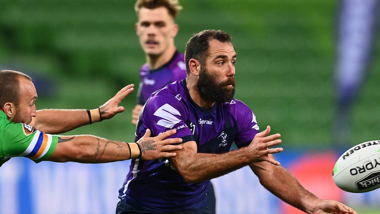 Cameron Smith of the Storm makes a pass in the defeat to Canberra
