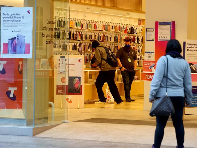 Customers and staff at the Telstra shop in Rundle Mall on Wednesday. Photo by Kelly Barnes/Getty Images.