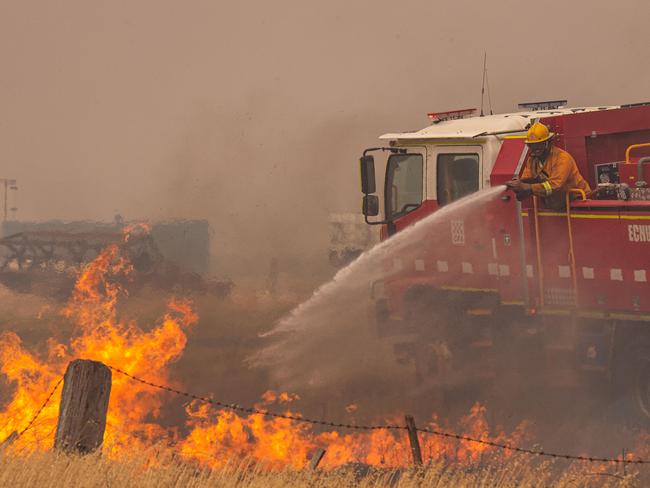 Echuca CFA tankers fight grass fires along Rochester-Strathallan road with the help of waterbombing air support helicopter     A fast moving grass fire impacts a farm, a railway line and destroys a shed and tractor just outside Rochester. Picture: Jason Edwards  Picture: Jason Edwards