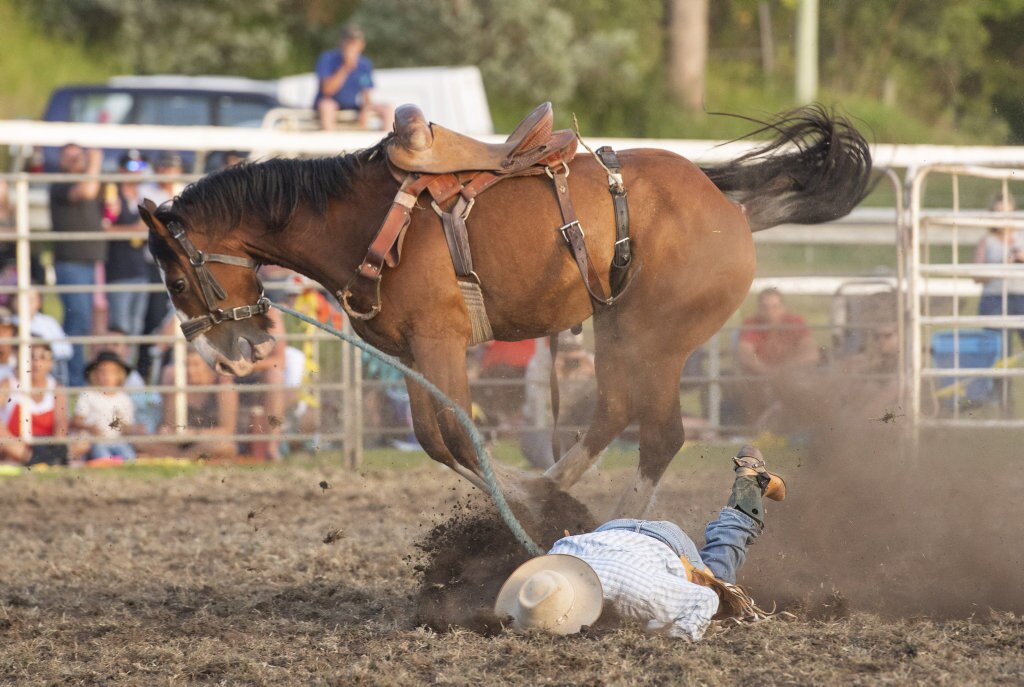 Sam Taylor cops a heavy fall in the saddle bronc event at the Maclean Twilight Rodeo. Picture: Adam Hourigan