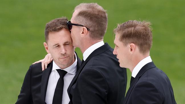 GEELONG, AUSTRALIA - FEBRUARY 14: (L-R) Joel Selwood, Adam Selwood and Scott Selwood embrace during Troy Selwood's Funeral Service at GMHBA Stadium on February 14, 2025 in Geelong, Australia. (Photo by Michael Willson/AFL Photos via Getty Images)