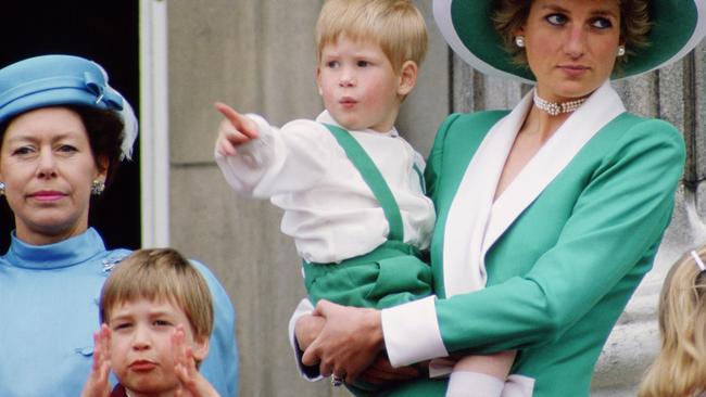 Diana, Princess of Wales, holding a young Prince Harry in her arms as she watches Trooping the Colour with Prince William. Picture: Tim Graham Photo Library via Getty Images