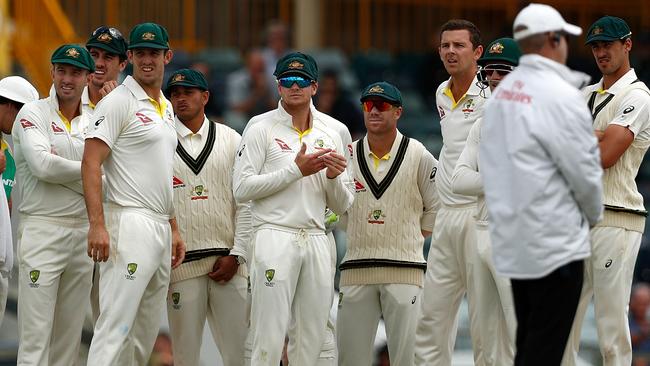 Steve Smith (centre) and the Australian team wait for the result of the umpire’s review.