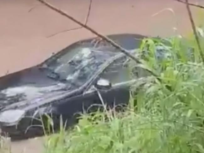 Footage shows a driver floating away in his Mercedes Benz in Queensland floodwaters.