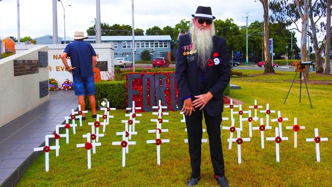 Logan historian Mic Noble at the Logan memorial on Monday where he marked Remembrance Day 2024 with his crosses for Logan heroes. Picture: Contributed