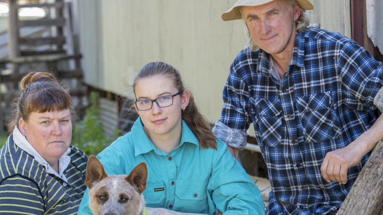 Narelle Mibus, daughter Zali, 17, husband Andrew and their dog Banjo at their farm in Moutajup in regional Victoria. They recently fell victim to a scammer who left them thousands of dollars out of pocket. Picture: Karla Northcott.