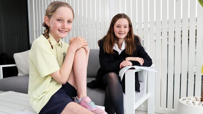 NAPLAN results for 2021 show that kids in primary school have done ok despite the pressures of home schooling but year 9 kids are now struggling. Pictured are the McKenna sisters Tilly 12 and Sally 8. Picture: Toby Zerna