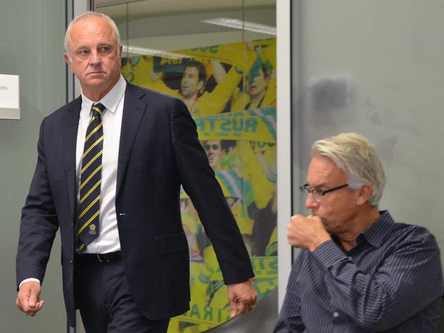 Australia's football head coach Graham Arnold (L) walks past Football Federation Australia (FFA) CEO David Gallop as he arrives for his first press conference in Sydney on August 9, 2018. (Photo by Peter PARKS / AFP) / -- IMAGE RESTRICTED TO EDITORIAL USE - STRICTLY NO COMMERCIAL USE --