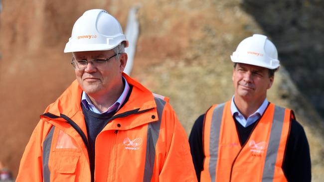 Scott Morrison and Energy Minister Angus Taylor at the start of drilling for Snowy 2.0 at Lobs Hole, near Mount Selwyn in the Snowy Mountains, in June. Picture: AAP