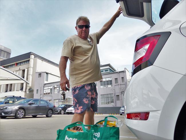 Townsville man Gavin Crews loads groceries into his car. Picture: Blair Jackson