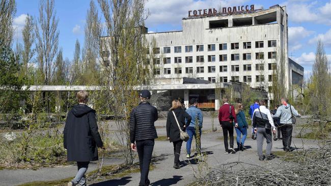 Tourists walk in the ghost city of Pripyat located near the Chernobyl nuclear power plant in 2018. Picture: AFP