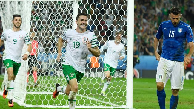 Robbie Brady (C) of Republic of Ireland celebrates scoring his team's key goal.