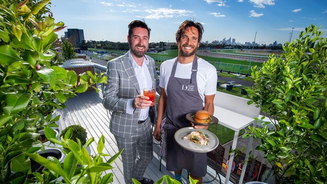 Dan Stock and Mark Labrooy on the rooftop of the Herald Sun marquee. Picture: Jay Town