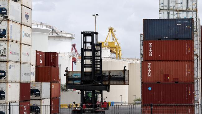 A worker moves containers at the compound of ports operator DP World at Port Botany. Picture: David Gray/AFP