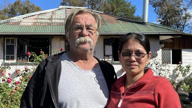 Timo Kent and Melanie Kent in front of their beloved home destroyed in the fire.