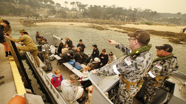 The first of the passengers are loaded on to the landing boats by ADF personal. Picture: David Caird