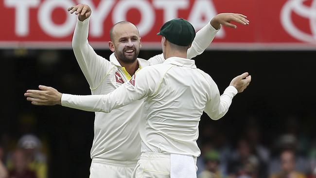 Nathan Lyon celebrates a wicket with Peter Handscomb.