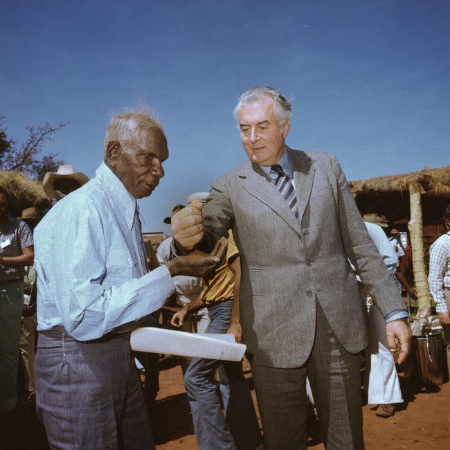 Gough Whitlam pouring sand into Vincent Lingiari’s hands.