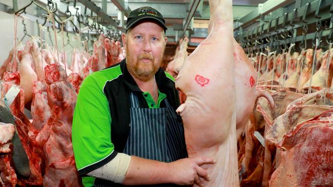 Pendle Hill Meat Market store manager Scott Lee with a prized pig in the cool room. Picture: Angelo Velardo