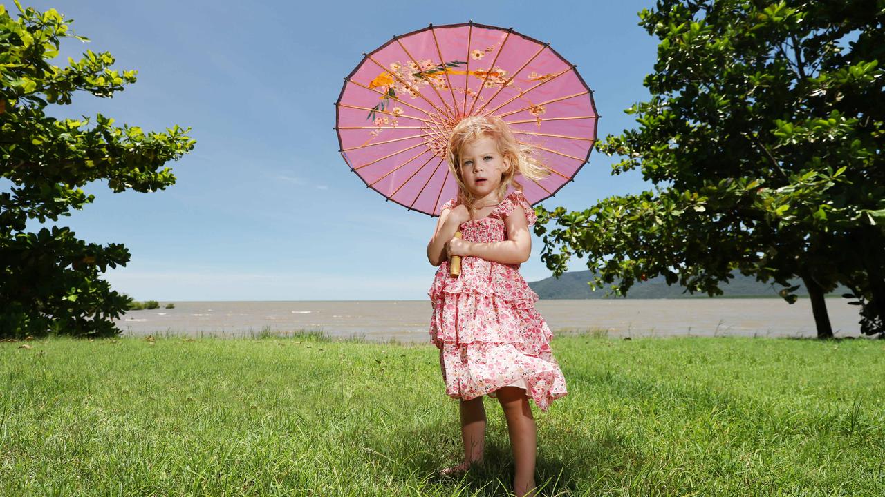 The persistent wet weather in Far North Queensland has finally cleared, giving way to sunshine and blue skies. Two year old Bonnie Crossman, from Mt Sheridan, enjoys the sunny day on the Cairns Esplanade, keeping the sun off her by using a parasol while out walking with her grandmother. Picture: Brendan Radke