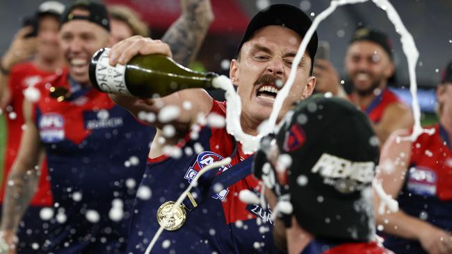 Jake Lever sprays champagne at premiership teammate Alex Neal-Bullen. Picture: Michael Klein