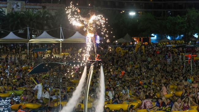 It’s festival time in the city of Wuhan as pool party guests watch a performance as they cool off from China’s summer of COVID. Picture: AFP