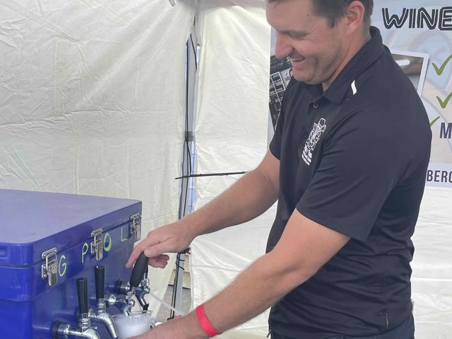 Joshua Phillips of Tiki Cider pours an apple cider at the Fraser Coast Flavours Festival at Seafront Oval on September 1, 2023.