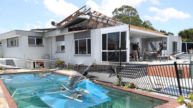 Residents survey the damage at Helensvale. Picture Glenn Hampson