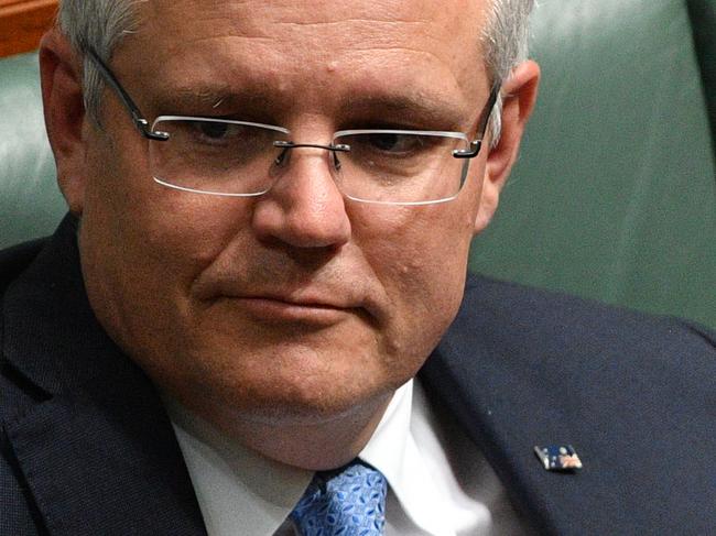 Prime Minister Scott Morrison with the Australia flag pin upside down during a division in the House of Representatives at Parliament House in Canberra, Monday, September 17, 2018. (AAP Image/Mick Tsikas) NO ARCHIVING