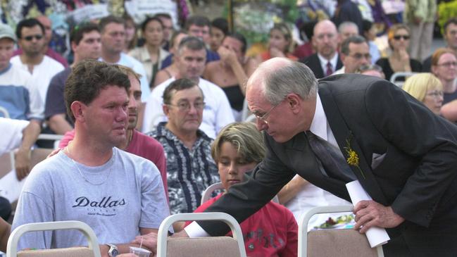 Prime Minister John Howard comforts Andrew Dark during a memorial service at the Australian Consulate in Bali on October 17, 2002.