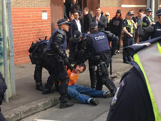 Police confront a man at the protests. Picture: Sophie Smith