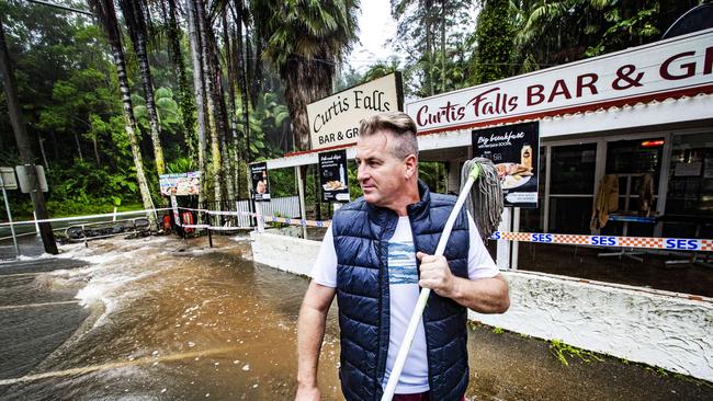 Mark Andrew from Curtis Falls Cafe, which was inundated with water. Picture: NIGEL HALLETT