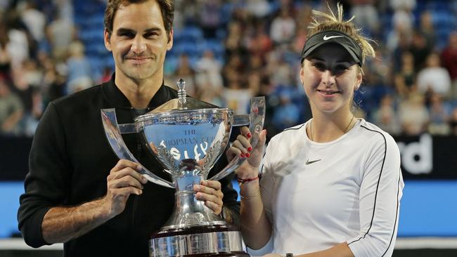 Roger Federer and Belinda Bencic of Switzerland celebrate with the Hopman Cup after their win in Perth on Saturday night. Picture: Getty Images 