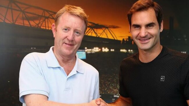 British tennis writer Mike Dickson, with Roger Federer, has died in Melbourne at the age of 59. Picture: Supplied