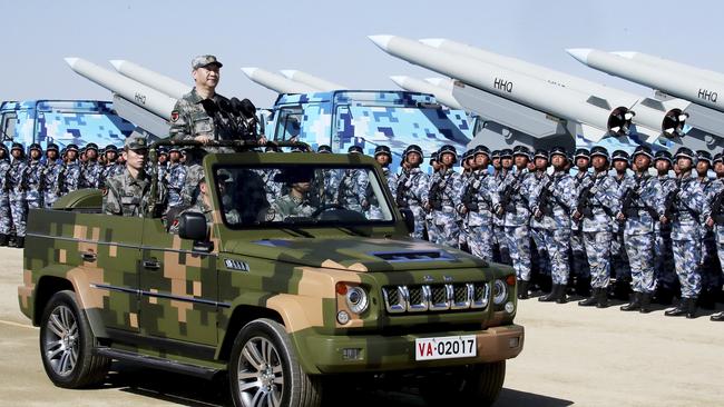 China’s newest armed missiles dwarf soldiers as Chinese President Xi Jinping inspects the parade. Picture: Li Tao/Xinhua via AP