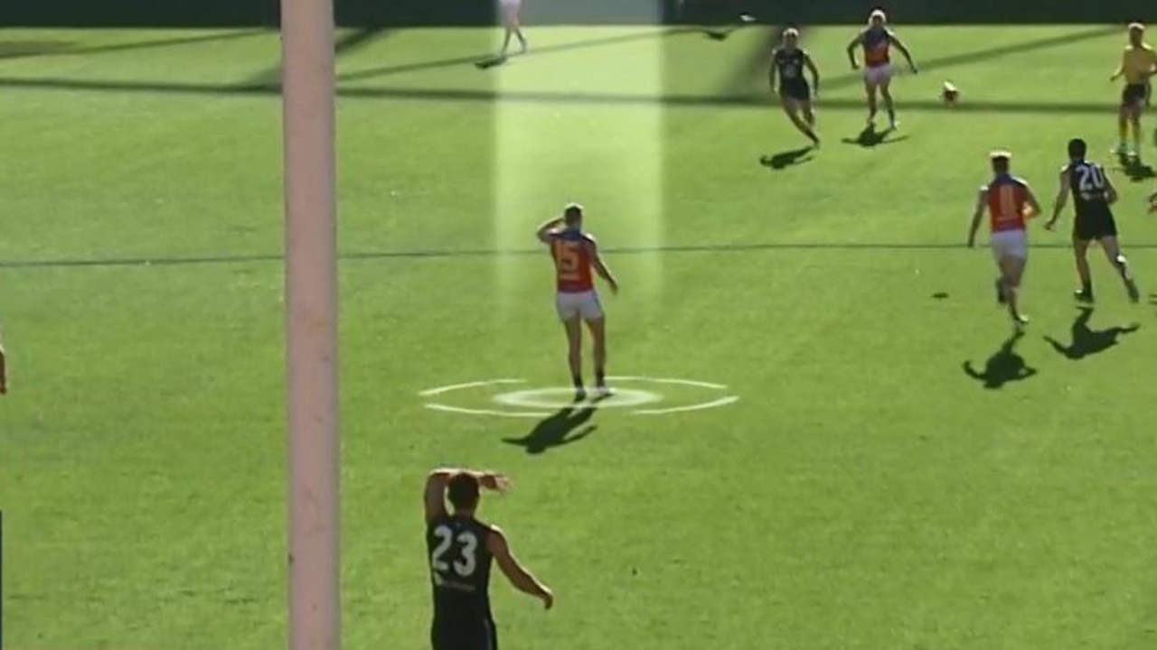 Dayne Zorko and Jacob Weitering (below) use their hand to shield the sun.