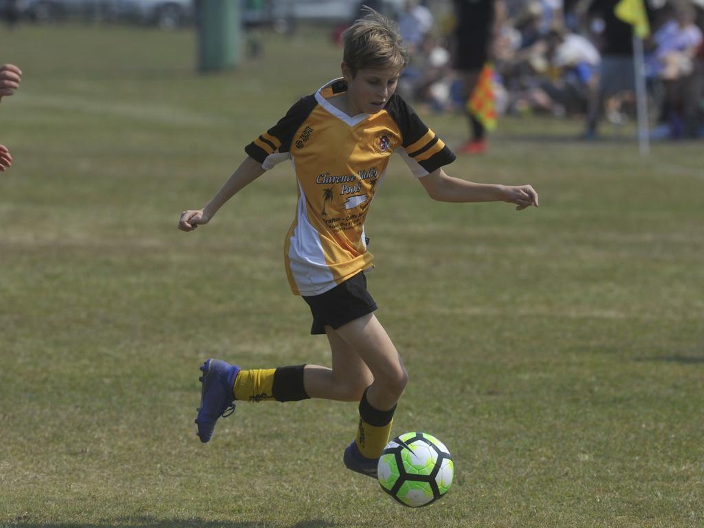 Westlawn Tigers' Koby Holland takes the ball against Yuraygir United in the 13s grand final at Yamba on Saturday.