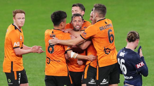 Scott McDonald of the Roar celebrates with teammates after scoring a goal. (Photo by Matt King/Getty Images)