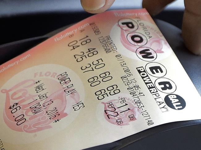 A clerk at a 7-Eleven store pulls Powerball tickets for a customer Wednesday, Jan. 13, 2016, in Tampa, Fla. The jackpot for tonight's drawing is over $1 billion. (AP Photo/Chris O'Meara)