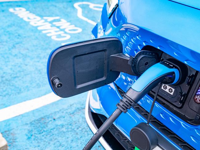 MG's new, affordable EV, MG4 , and EV charging at a station