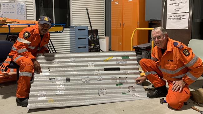 SES Mackay members Mick Beezley and Nev Ross with a very well patched roof. Picture: Tara Miko