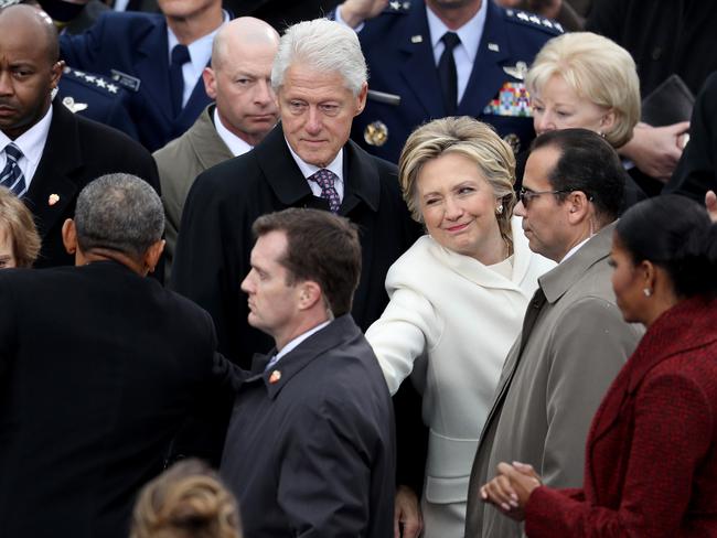 Former Democratic presidential nominee Hillary Clinton winks and shakes hands with President Barack Obama as former president Bill Clinton and Michelle Obama look on at the West Front of the U.S. Capitol on January 20, 2017 in Washington, DC. Picture: AFP