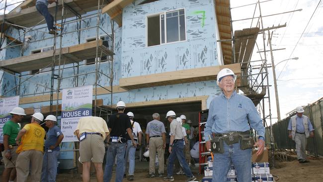 Jimmy Carter strolls the worksite at the Habitat For Humanity Work Project in San Pedro, California, in 2007. The former president and Nobel Peace Prize laureate joined hundreds of volunteers from around the world to help low-income families realise home ownership. Picture: Getty Images