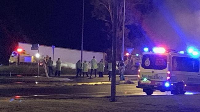 Emergency workers at scene of the Bruce Highway crash at Maryborough in which three people died.