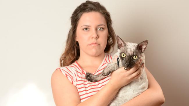 Casey Thomson with her cat Jett who after it had been shaved. Picture: Lawrence Pinder