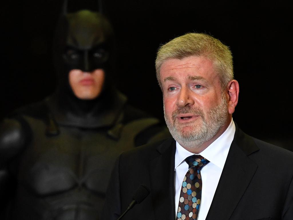 Federal Minister for Communication and the Arts Mitch Fifield, flanked by Batman, during a press conference at Village Roadshow Studios on the Gold Coast. Picture: AAP Image/Dan Peled.