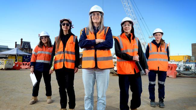 AFLW player and John Holland finance officer Kirsten McLeod (centre) with engineers Monica Santos-Chaney, Maria Agudelo, Lauren Knights and Libby Paynter at the Hobsons Bay main sewer upgrade project. Picture: Andrew Henshaw