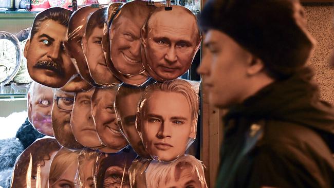 Masks of Russian President Vladimir Putin on sale at a souvenir kiosk in central Saint Petersburg. Picture: AFP