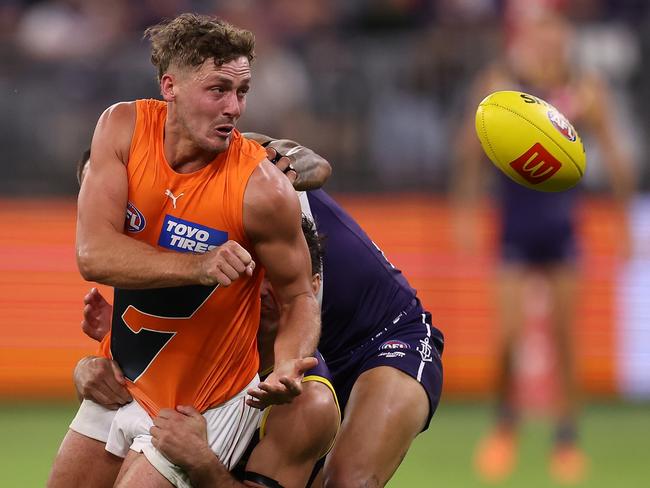 PERTH, AUSTRALIA - APRIL 09: Harry Perryman of the Giants handballs during the round four AFL match between the Fremantle Dockers and the Greater Western Sydney Giants at Optus Stadium on April 09, 2022 in Perth, Australia. (Photo by Paul Kane/Getty Images)